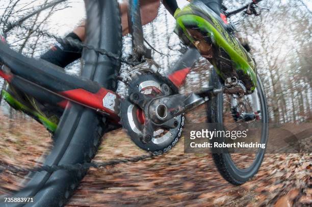 low section of mountain biker speeding on forest track - ペダル ストックフォトと画像
