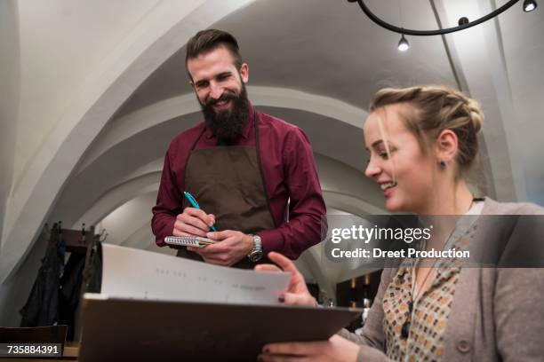 woman in restaurant placing order - business people holding menus in restaurant stock pictures, royalty-free photos & images