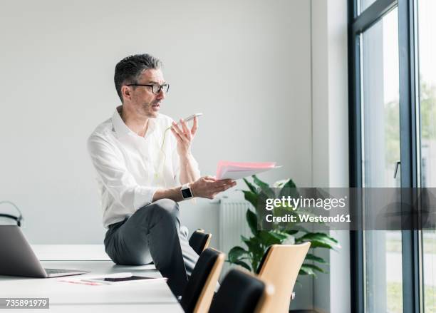 businessman using cell phone in a conference room - 48 hours stock-fotos und bilder