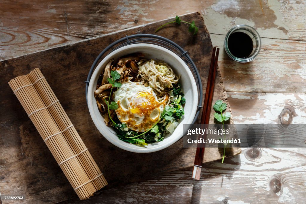 Buddha Bowl of spinach, mushrooms, noodels and fried egg