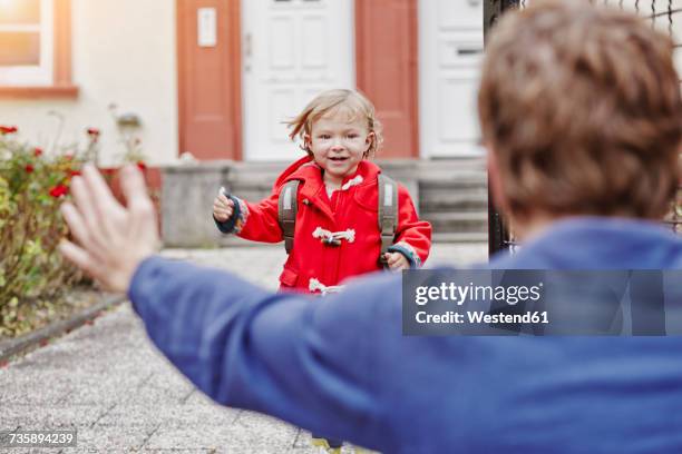 happy daughter approacing father at house entrance - divorce kids fotografías e imágenes de stock