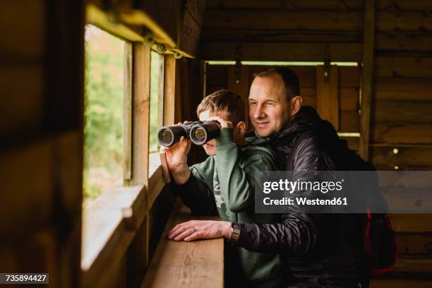 boy and father birdwatching with binoculars - viewing binoculars stock pictures, royalty-free photos & images