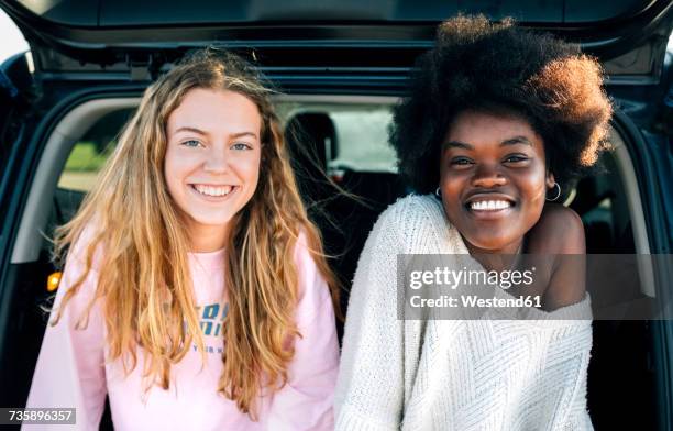 portrait of two best friends sitting in a car - two cars side by side stock pictures, royalty-free photos & images