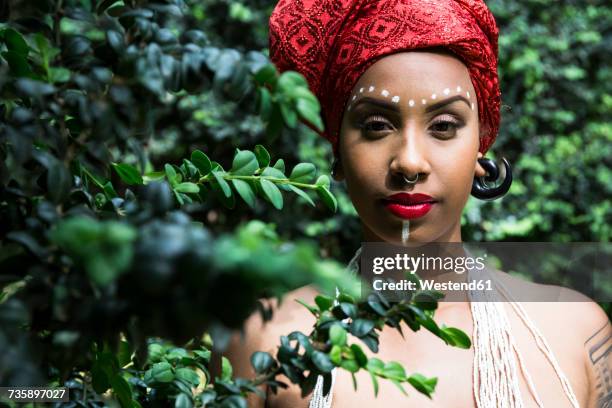 portrait of young woman with piercings wearing traditional brazilian headgear - traditional piercings stock pictures, royalty-free photos & images