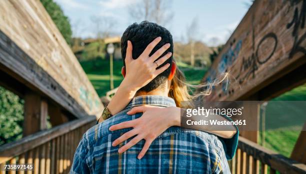 back view of young man kissed by his girlfriend - kisses the hand stock pictures, royalty-free photos & images