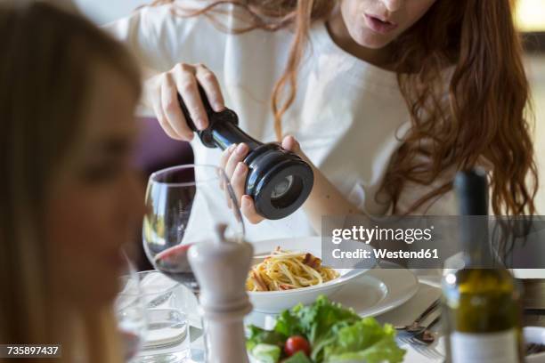 friends eating together spaghetti carbonara - pepper mill stock pictures, royalty-free photos & images