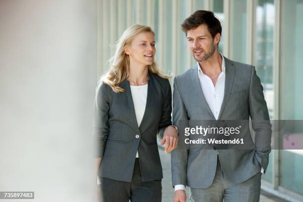 portrait of two talking businesspeople - gray suit stock pictures, royalty-free photos & images