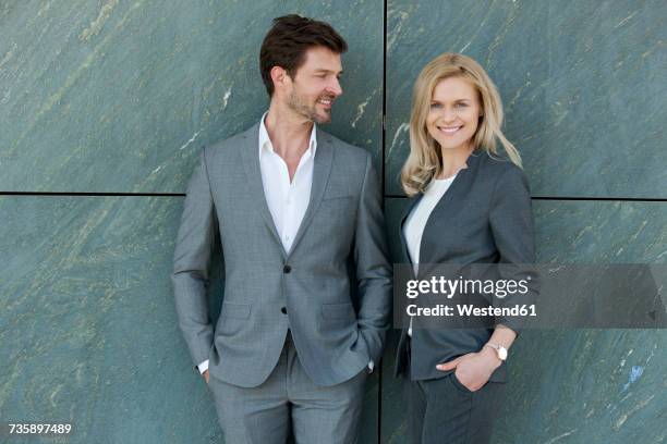 portrait of two smiling businesspeople - pant suit stockfoto's en -beelden