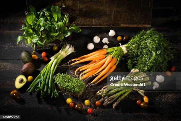 various organic vegetables on dark wood - herb bundle stock pictures, royalty-free photos & images