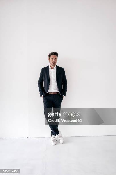 portrait of confident businessman standing with hands in pockets - white jacket stock pictures, royalty-free photos & images