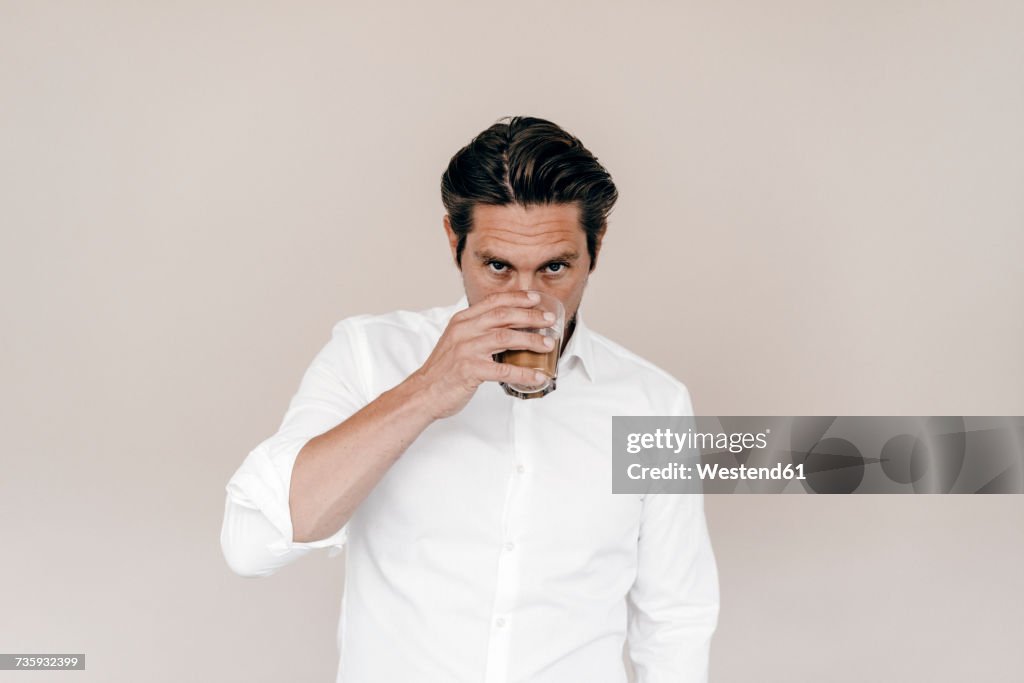 Businessman drinking from glass