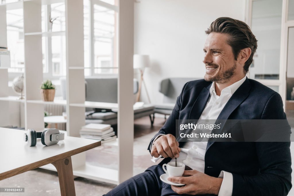 Smiling businessman having a coffee break