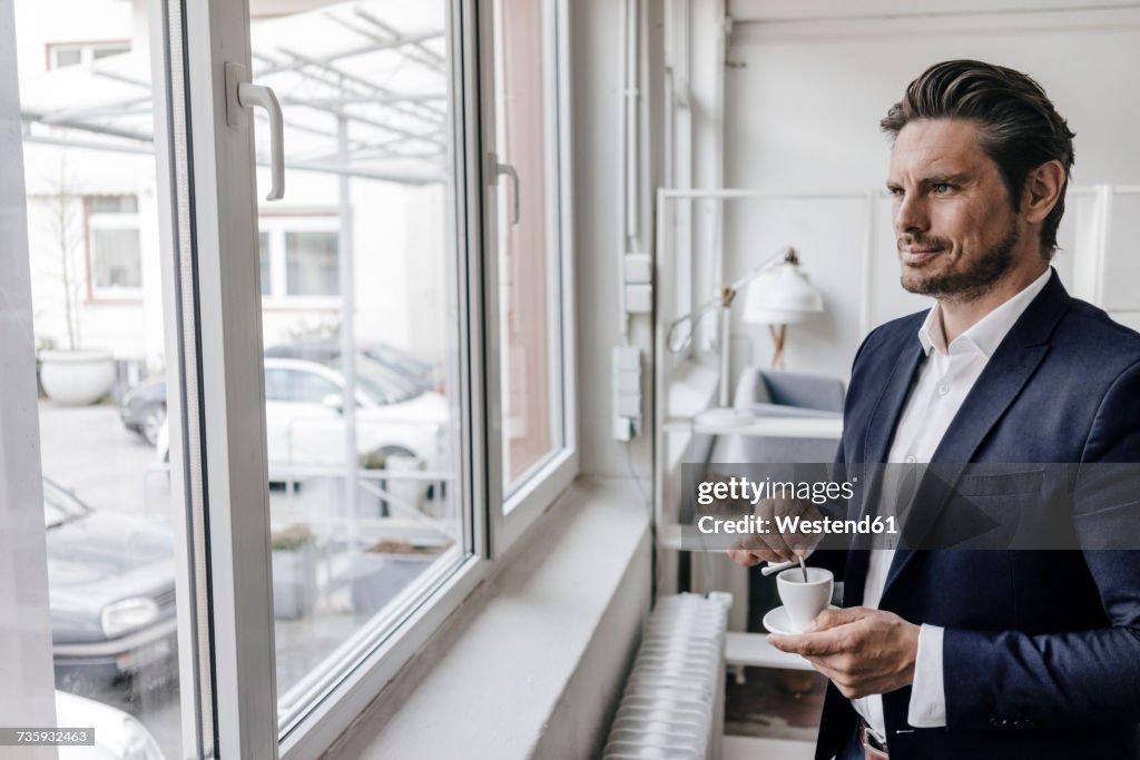 Businessman having a coffee at the window