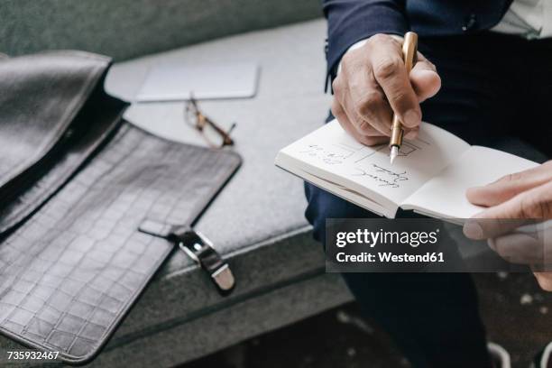 close-up of businessman writing and drawing in notebook - sketch pad stock pictures, royalty-free photos & images