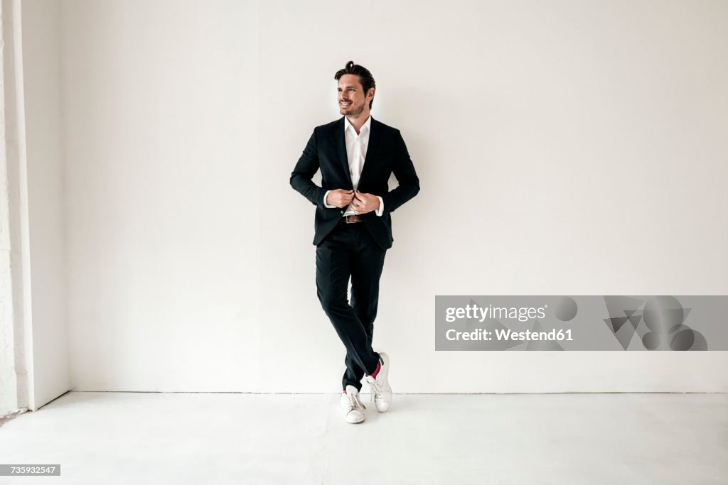 Confident businessman standing in empty room