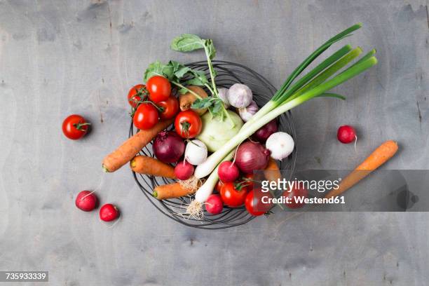 wire basket with different vegetables on wood - バスケット ストックフォトと画像