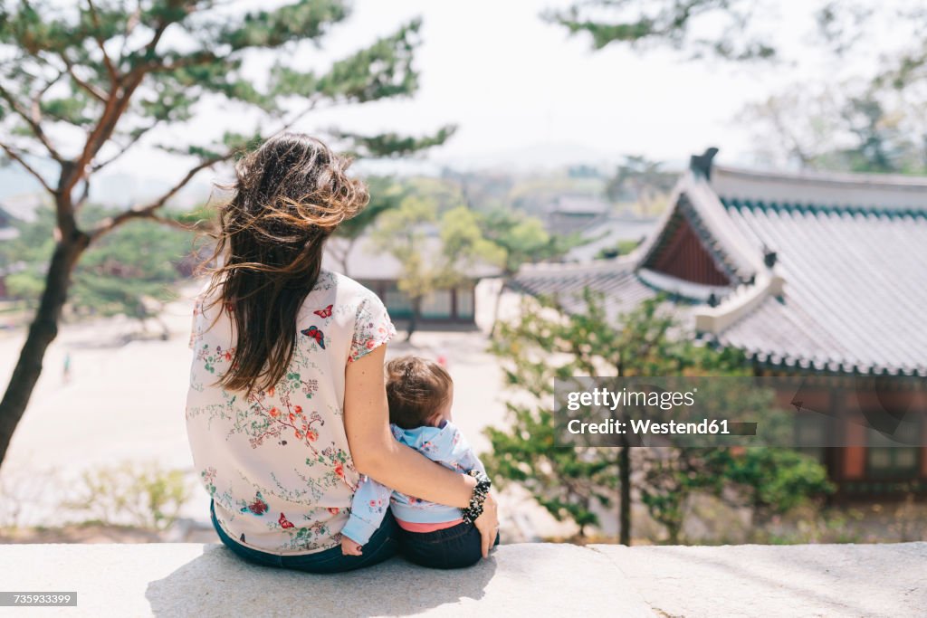 South Korea, Seoul, Mother and baby girl visiting Changdeokgung Palace and Huwon