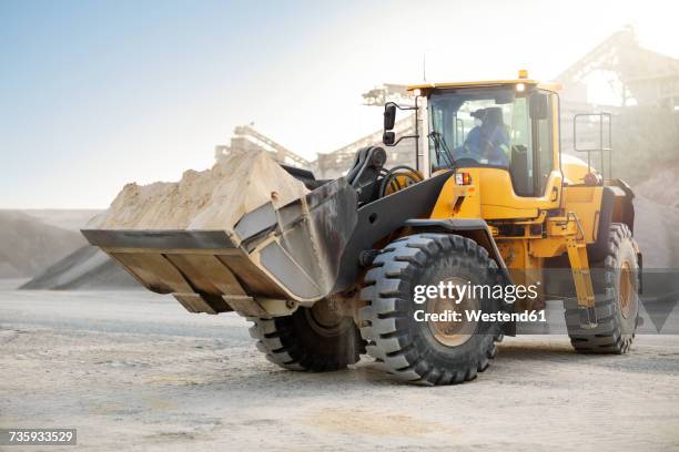 digger working at quarry - earth mover stock pictures, royalty-free photos & images