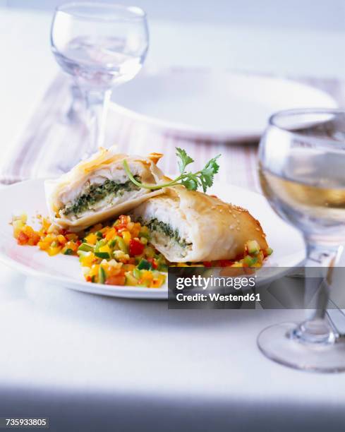 fish wrapped in filo dough with ratatouille - ratatuia foto e immagini stock