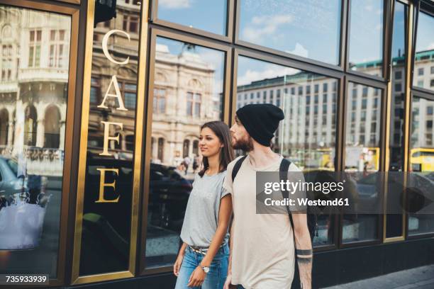 austria, vienna, young couple walking in front of a coffee shop - james last awarded badge of honour by city of vienna stockfoto's en -beelden