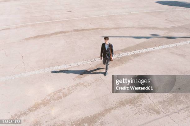 young man in suit walking - man walking top view stock pictures, royalty-free photos & images