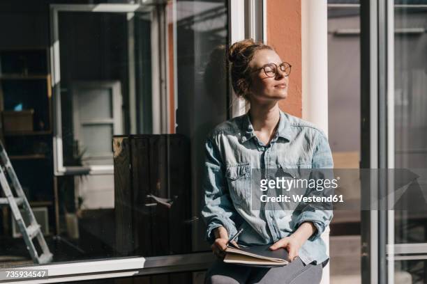 young woman with glasses in sunlight - tranquility stock-fotos und bilder