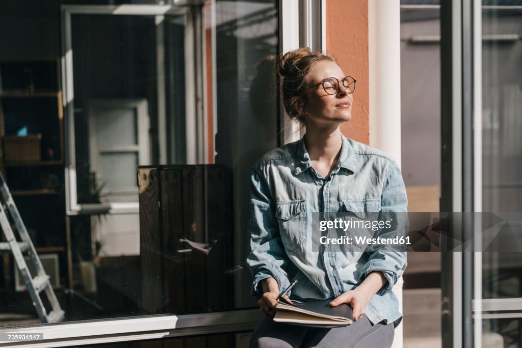 Young woman with glasses in sunlight