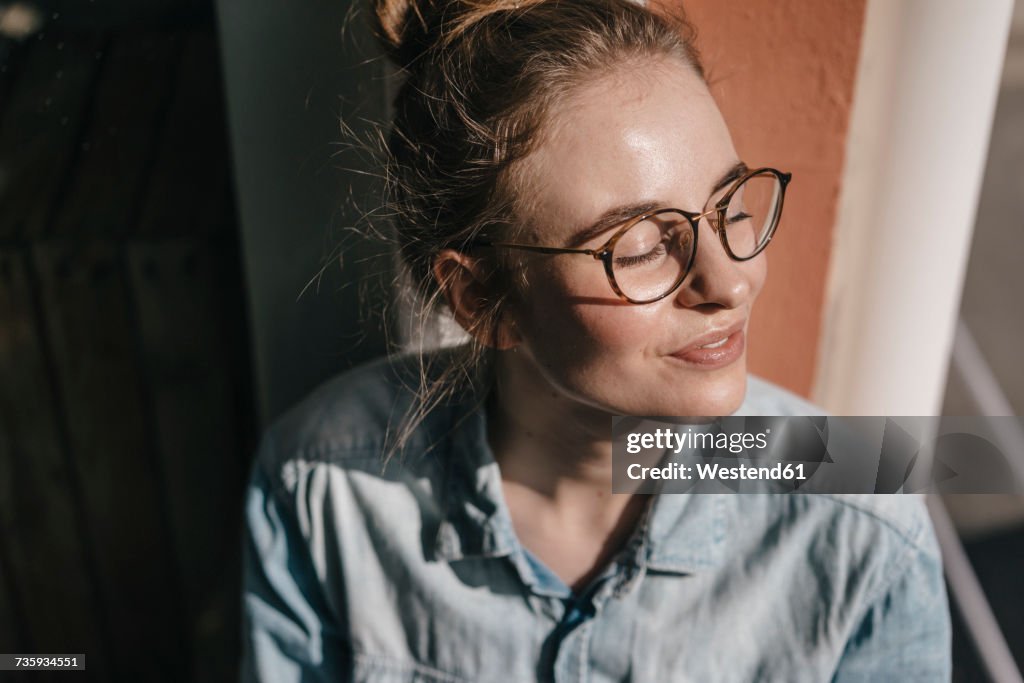 Young woman with glasses in sunlight