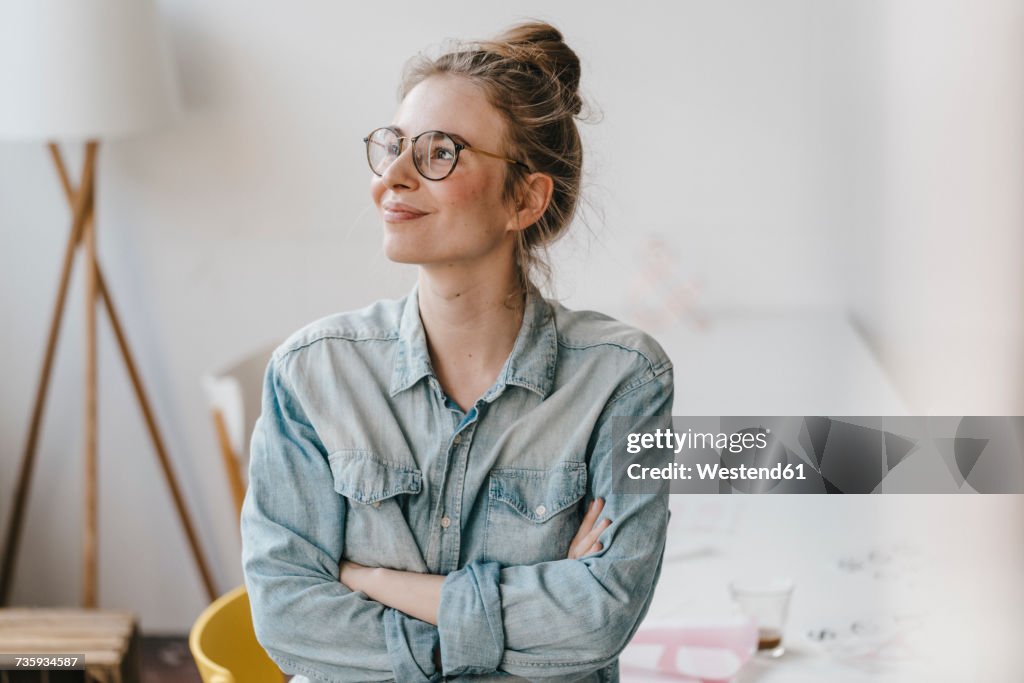 Smiling young woman in office looking sideways