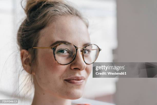 portrait of young woman with glasses - woman unique features stock-fotos und bilder