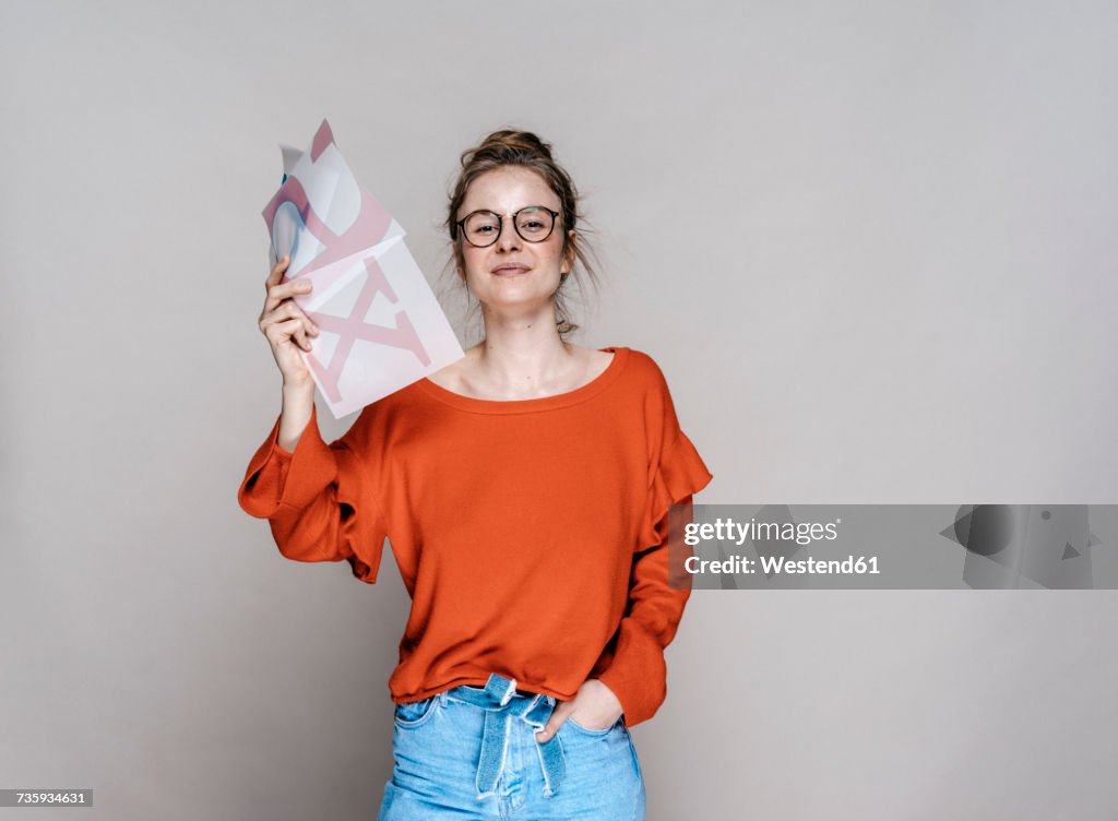 Portrait of young woman holding letter x template