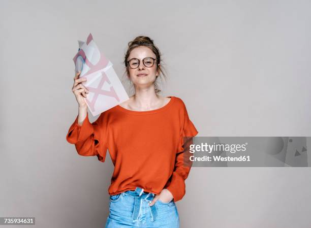 portrait of young woman holding letter x template - honors show stock pictures, royalty-free photos & images