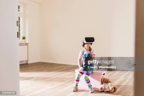 girl in empty apartment wearing vr glasses - vr kids stock pictures, royalty-free photos & images