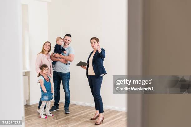 real estate agent and family in new apartment - visit stock-fotos und bilder