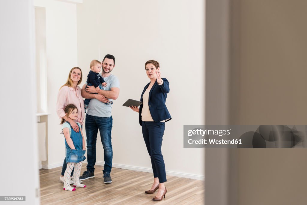 Real estate agent and family in new apartment