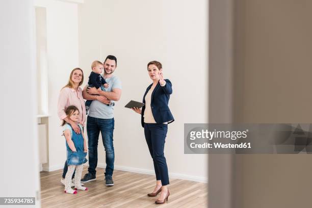 real estate agent and family in new apartment - family visit stock pictures, royalty-free photos & images