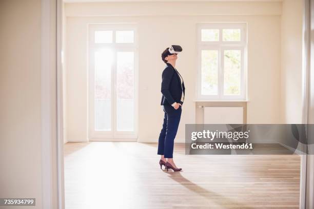 woman in empty apartment wearing vr glasses - vr glasses bildbanksfoton och bilder