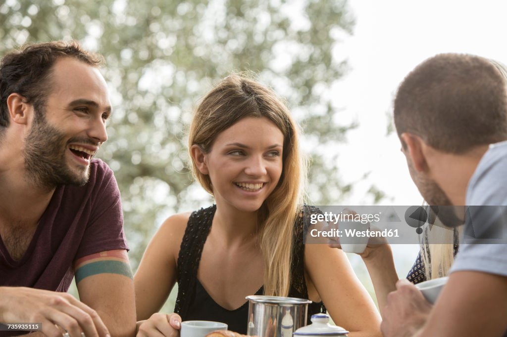 Four friends having fun at breakfast table