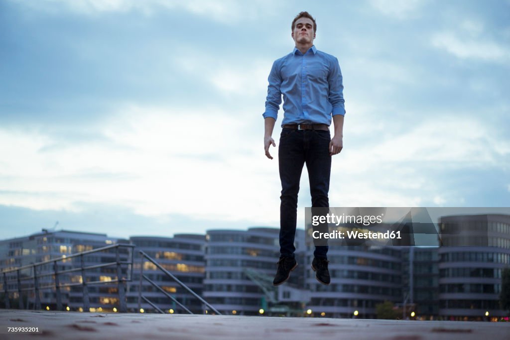 Portrait of young man jumping in the air