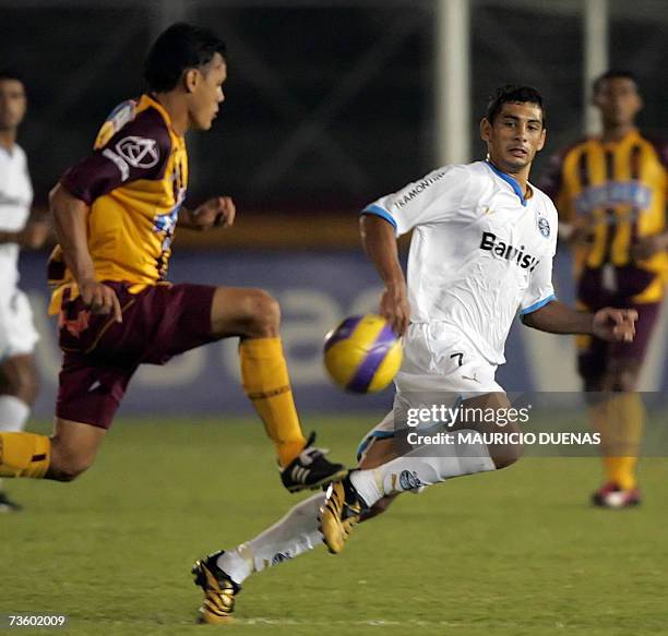 Diego Souza of Brazil's Gremio vies for the ball with Hernando Patino of Colombia's Deportes Tolima during a Libertadores Cup football match 15 March...