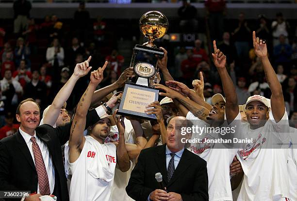 The Ohio State Buckeyes celebrate as they are presented with the trophy by Big Ten Commissioner Jim Delany following Ohio St.'s 66-49 win against the...