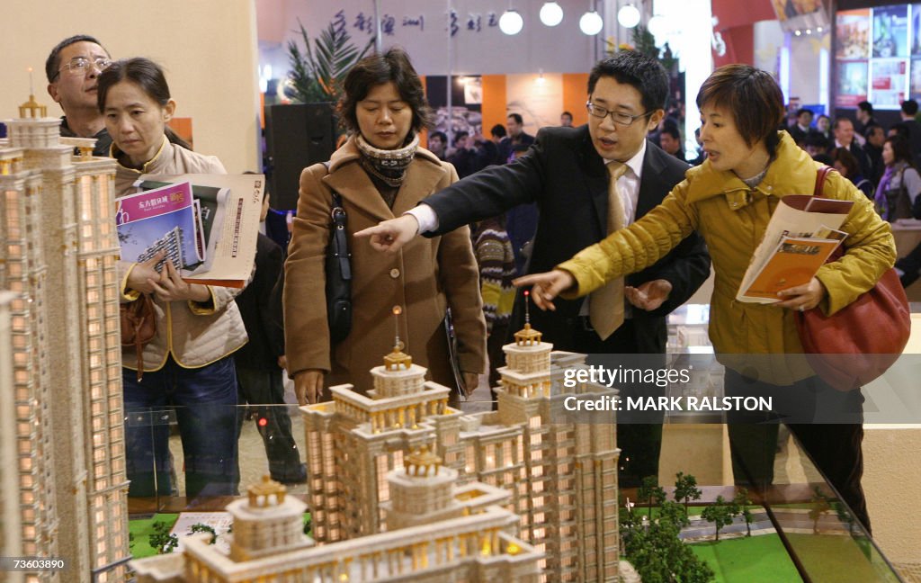 Chinese investors talk with a property s...