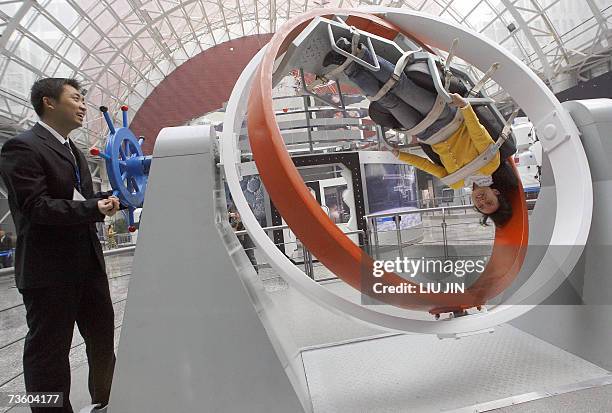 Visitor tries the three-dimensional rolling hoop, one of the basic training items for astronauts and pilots at the Sichuan Science and Technology...