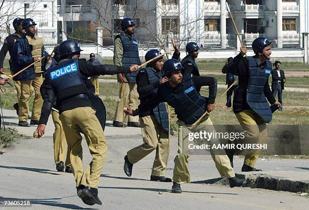 Pakistani riot police throw stones towards unsee protesters during a demonstration against the sacking of Chief Justice Iftikhar Muhammad Chaudhry,...