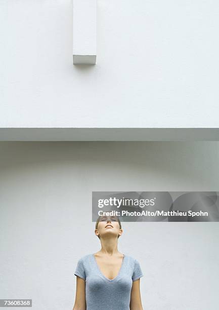 woman standing with head back and eyes closed, waist up - woman front and back stock-fotos und bilder