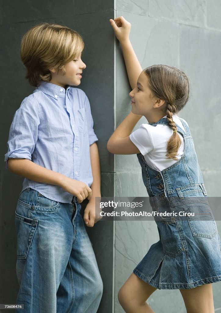 Boy and girl standing face to face, portrait