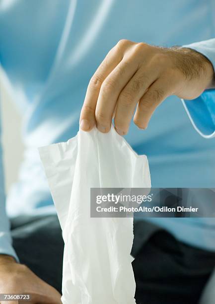 man taking face tissue - fazzoletto foto e immagini stock