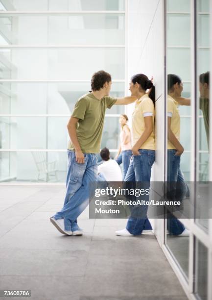 teen couple leaning against wall - college girl profile stock pictures, royalty-free photos & images
