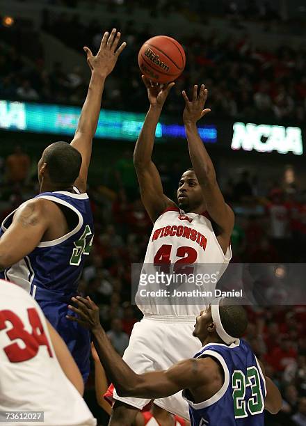 Alando Tucker of the Wisconsin Badgers attempts a shot against Chris Daniels and Kevin Menifee of the Texas A&M - Corpus Christi Islanders during the...