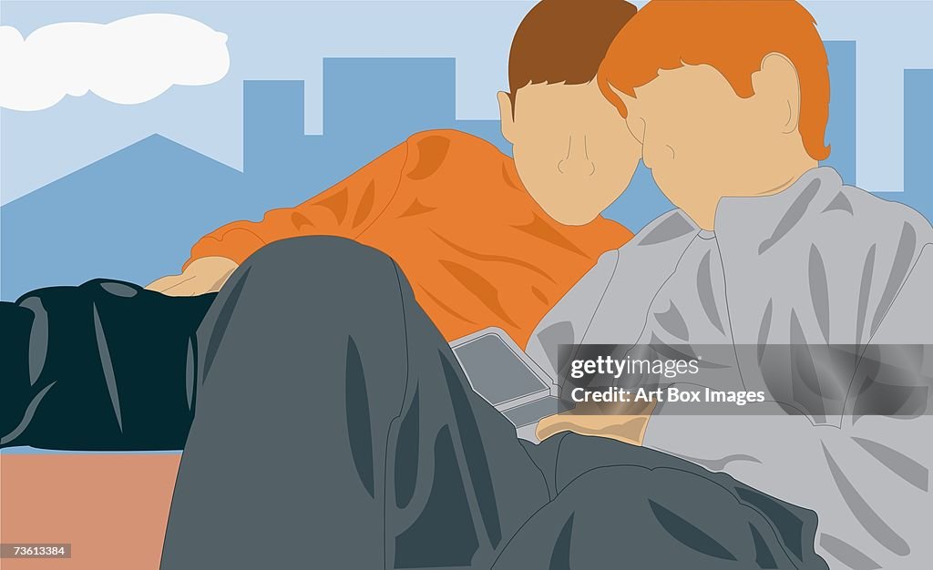 Close-up of two men operating a mobile phone